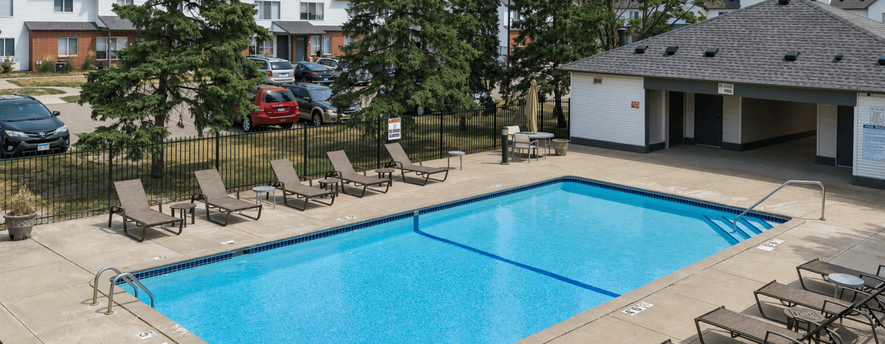 Swimming pool with chairs around the sundeck