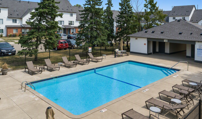 Swimming pool with chairs around the sundeck