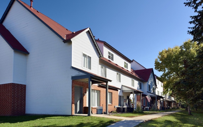 a row of apartment homes near trees