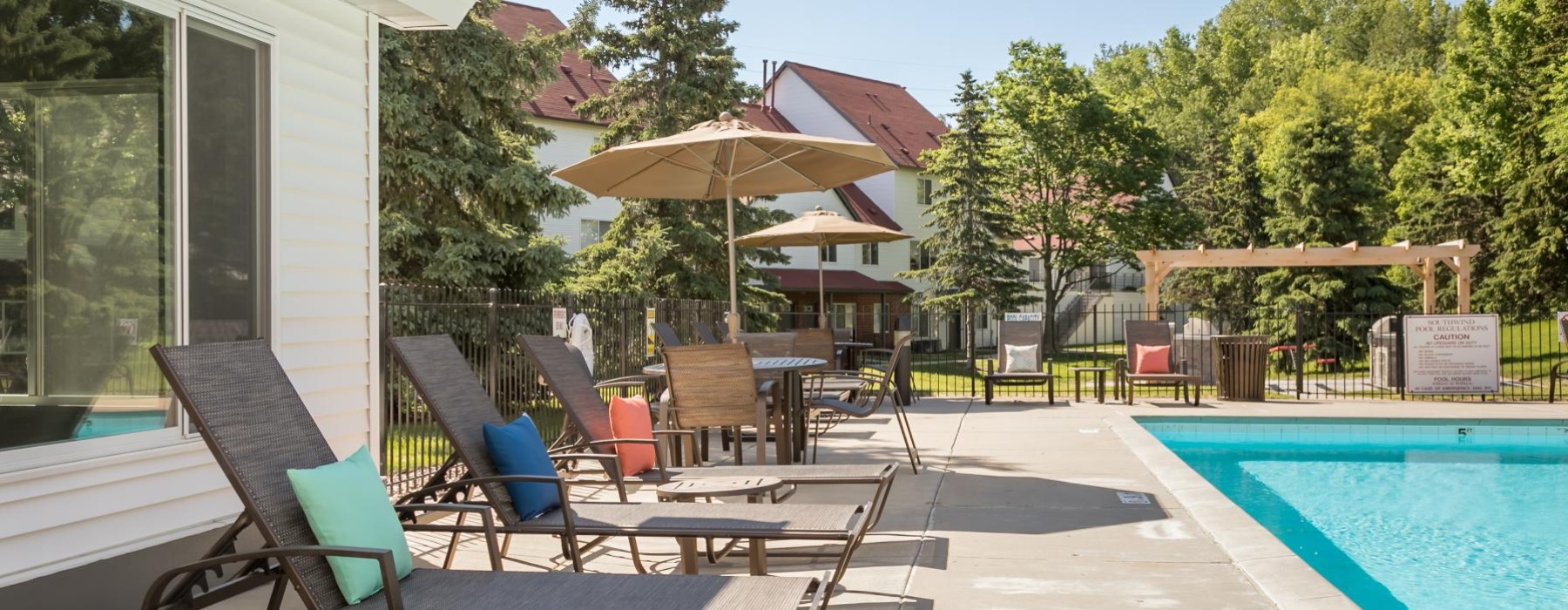 a pool with chairs and umbrellas