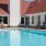 a swimming pool with chairs around it