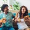 A group of friends on the couch holding drinks